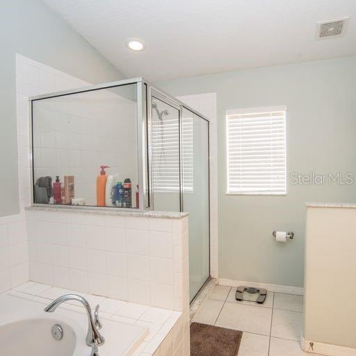 bathroom featuring tile patterned floors and plus walk in shower