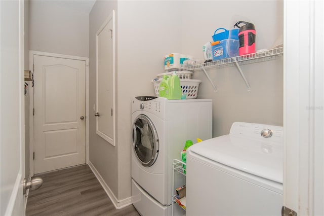 laundry room featuring dark hardwood / wood-style flooring and washing machine and clothes dryer