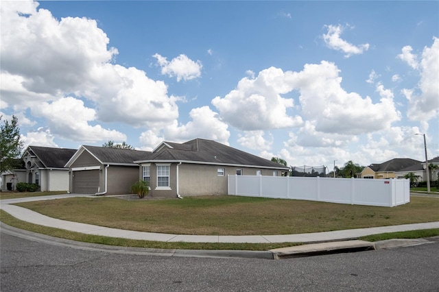 view of front of house featuring a garage and a front lawn