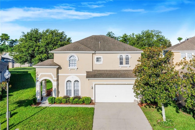 view of front of house featuring a garage and a front lawn