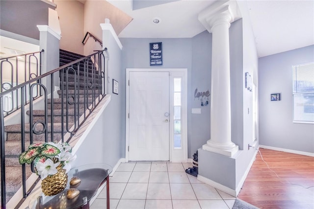 foyer entrance with decorative columns and wood-type flooring