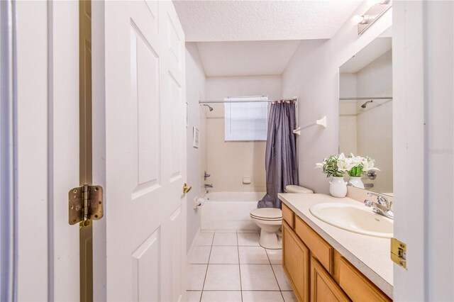 full bathroom featuring vanity, tile patterned floors, shower / bath combo, toilet, and a textured ceiling