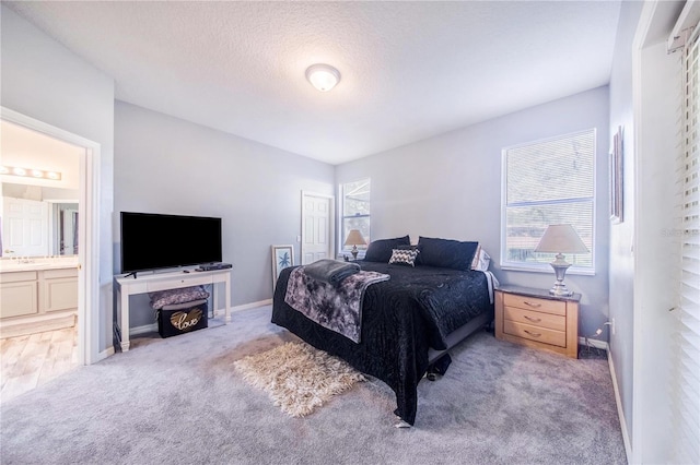 carpeted bedroom featuring ensuite bath and a closet