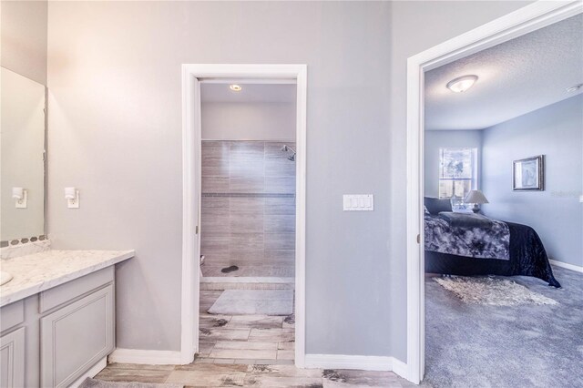 bathroom with vanity and a textured ceiling