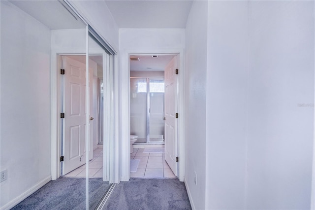 corridor with light colored carpet