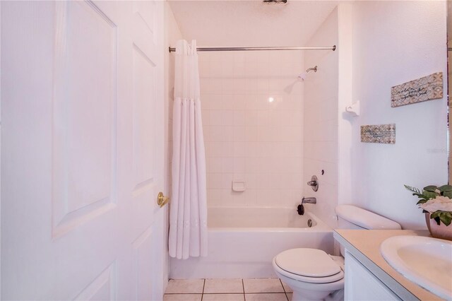 full bathroom with shower / bath combination with curtain, vanity, tile patterned floors, and toilet