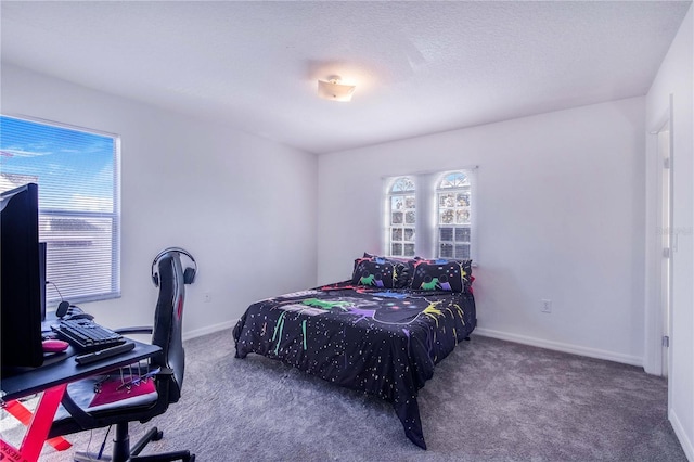 carpeted bedroom featuring a textured ceiling