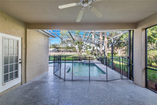 view of pool featuring ceiling fan, glass enclosure, and a patio area