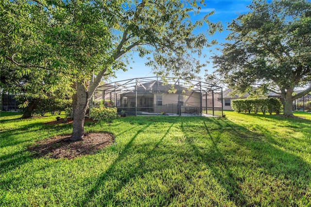 view of yard with glass enclosure