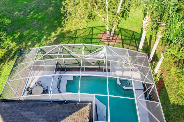 view of swimming pool with a lawn and an in ground hot tub