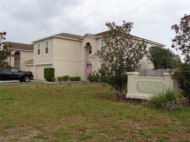 view of front of property featuring a garage and a front yard