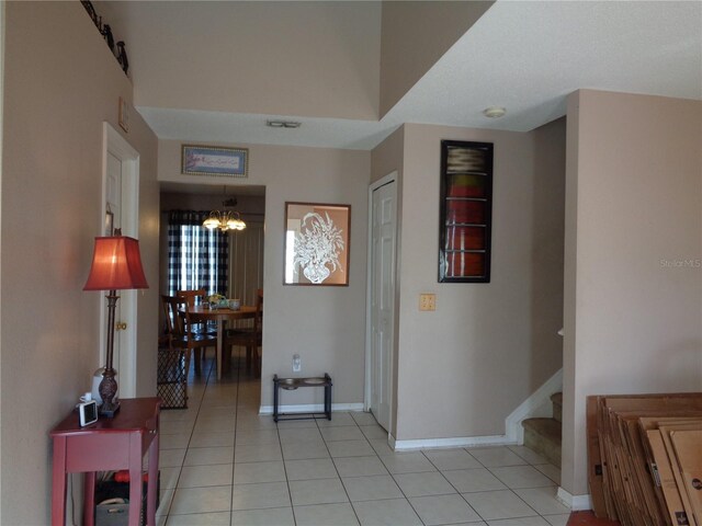 tiled foyer entrance featuring a chandelier