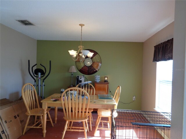 dining area with hardwood / wood-style flooring and a chandelier