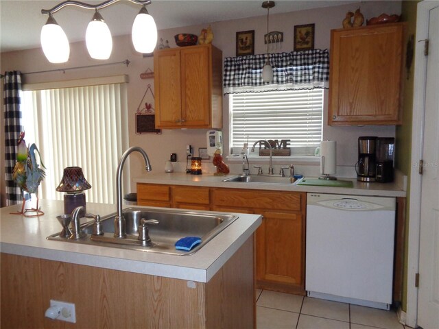 kitchen featuring a wealth of natural light, sink, and white dishwasher