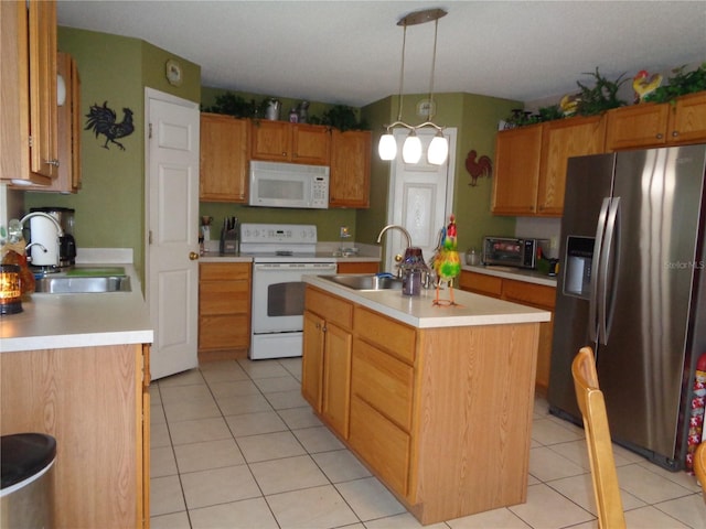 kitchen with white appliances, light tile patterned floors, a center island with sink, hanging light fixtures, and sink