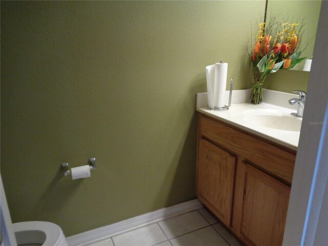 bathroom with vanity, toilet, and tile patterned floors