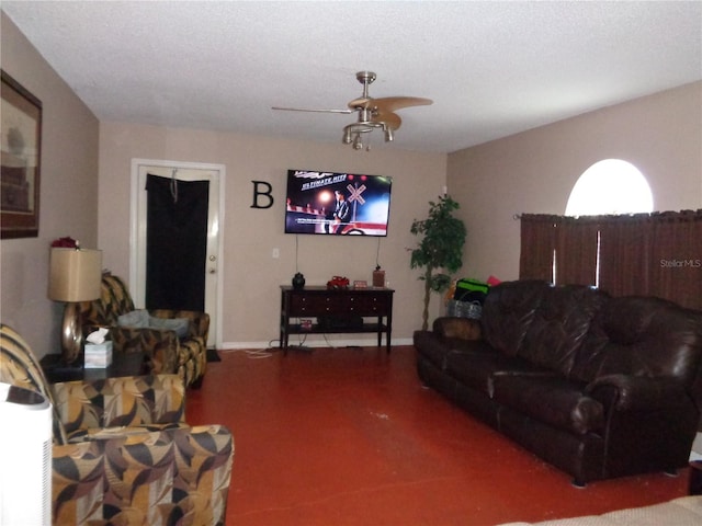 living area featuring ceiling fan, a textured ceiling, and concrete flooring