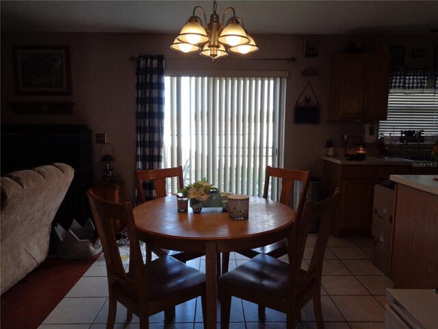 tiled dining space featuring a notable chandelier