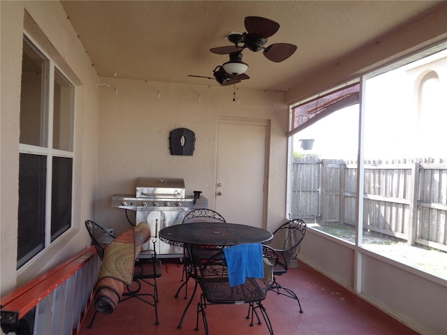 sunroom featuring ceiling fan