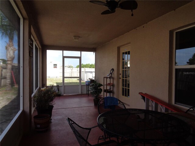 sunroom featuring ceiling fan