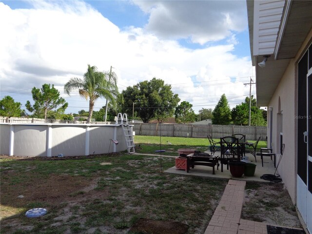 view of yard with a patio area and a fenced in pool