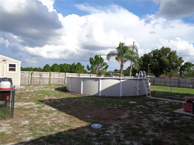 view of yard with a fenced in pool