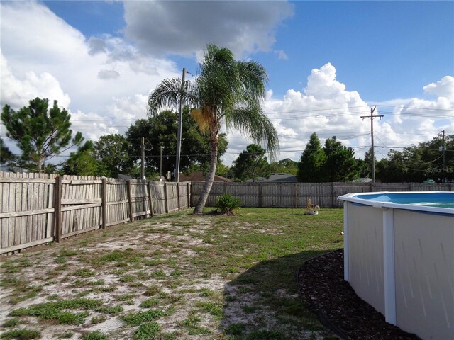 view of yard with a fenced in pool