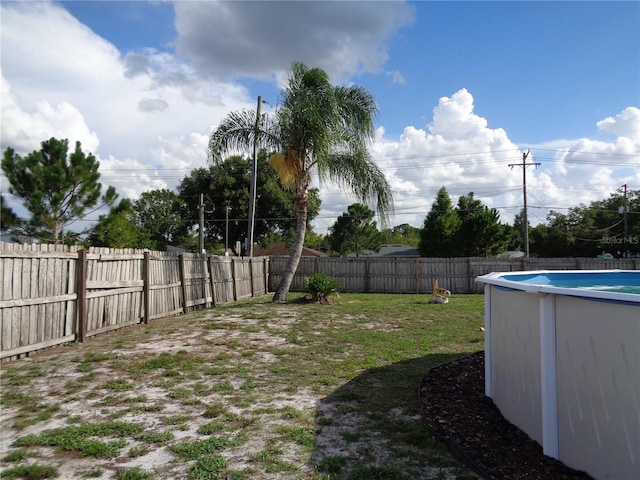 view of yard with a fenced in pool and a fenced backyard