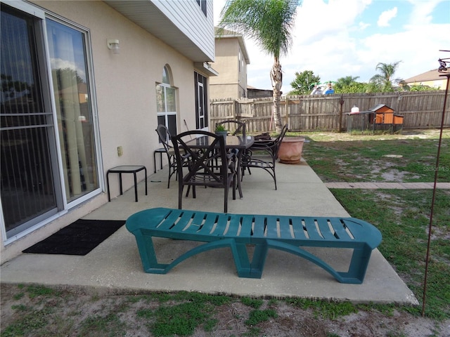 view of patio featuring outdoor dining area and fence