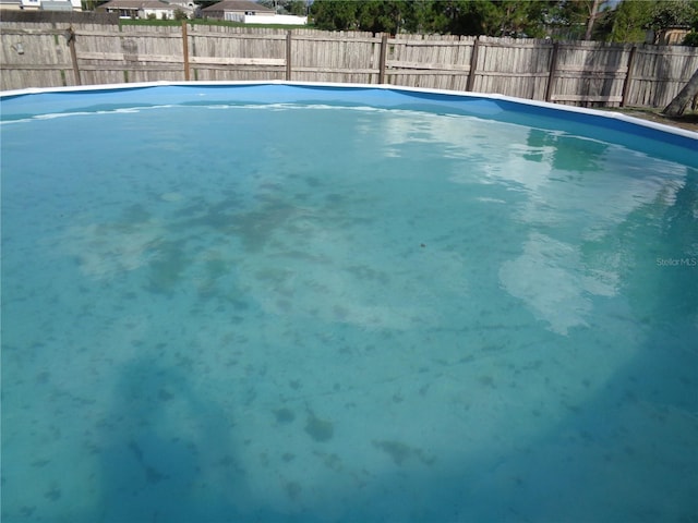 view of swimming pool with a fenced backyard and a fenced in pool