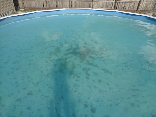 view of swimming pool with a fenced backyard and a fenced in pool