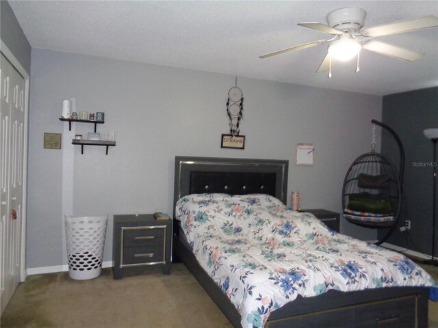 bedroom with ceiling fan, a closet, and carpet flooring