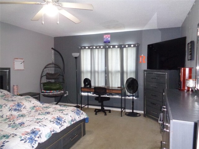 bedroom featuring light carpet and ceiling fan