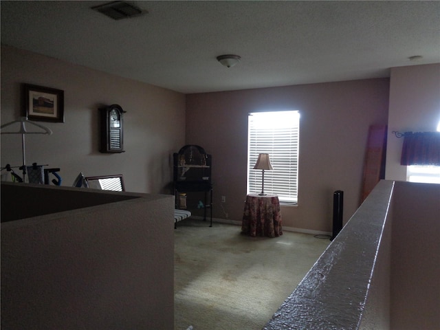 bedroom featuring baseboards, visible vents, and light colored carpet