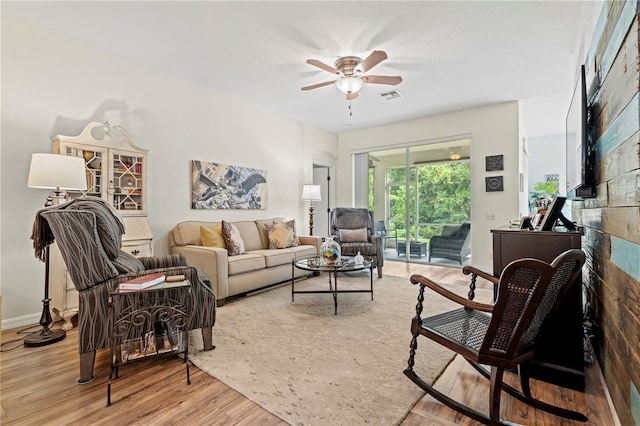 living room featuring light wood-type flooring and ceiling fan