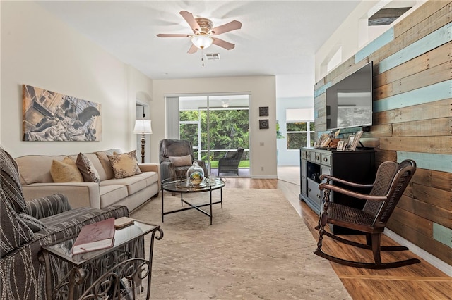 living room featuring ceiling fan and light hardwood / wood-style floors