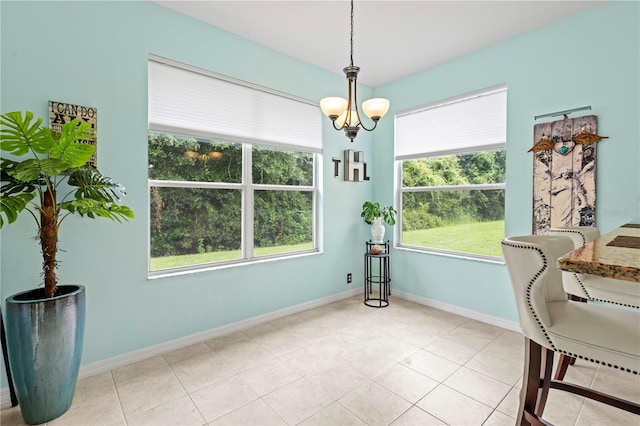 dining room featuring light tile patterned floors and a chandelier