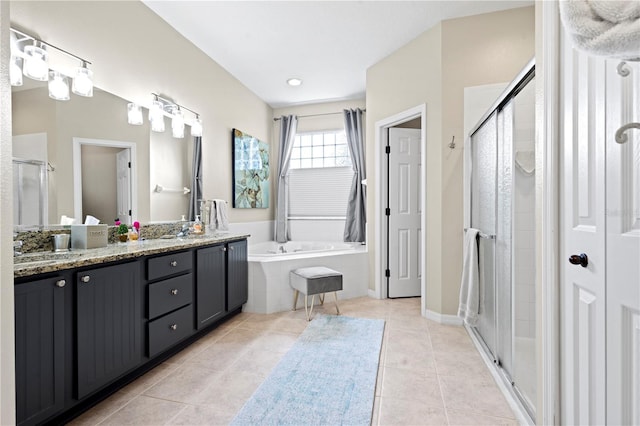 bathroom featuring vanity, independent shower and bath, and tile patterned floors