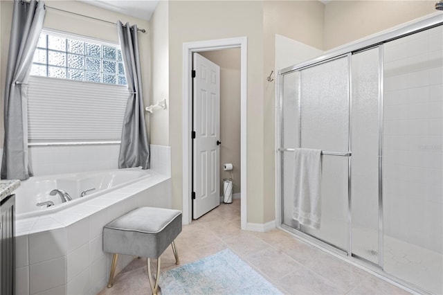 bathroom featuring tile patterned floors and independent shower and bath