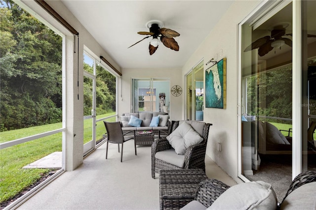 sunroom / solarium featuring ceiling fan