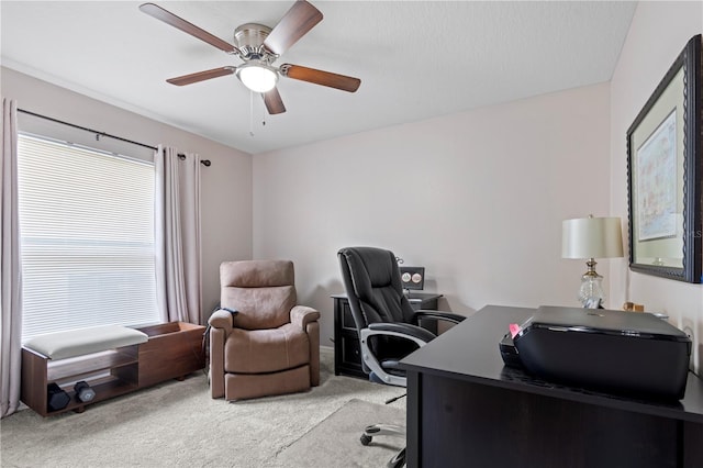 office space featuring light carpet, ceiling fan, and a wealth of natural light