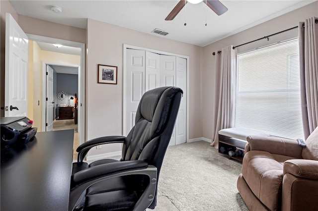 carpeted office space with ceiling fan