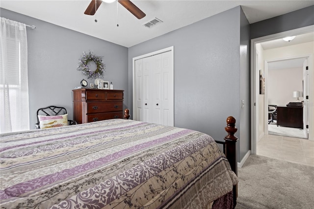 carpeted bedroom with ceiling fan and a closet