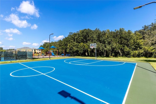 view of sport court with a playground