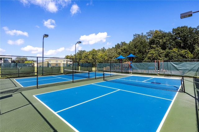 view of sport court featuring a playground