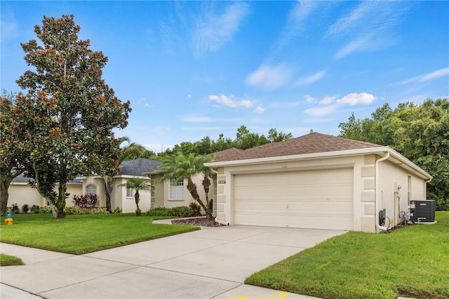 ranch-style home with a front lawn, a garage, and central air condition unit