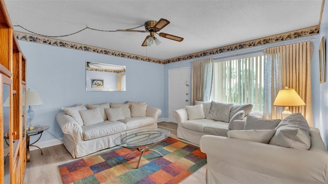 1600 W Lake Parker Dr Unit A2, Lakeland, FL 33805 - living area featuring a ceiling fan, baseboards, a textured ceiling, and wood finished floors