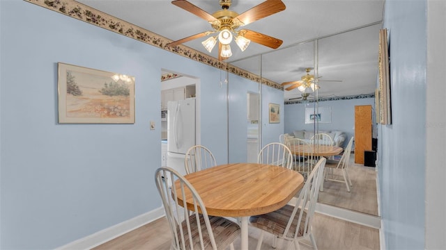 1600 W Lake Parker Dr Unit A2, Lakeland, FL 33805 - dining room featuring a ceiling fan, baseboards, and light wood-type flooring