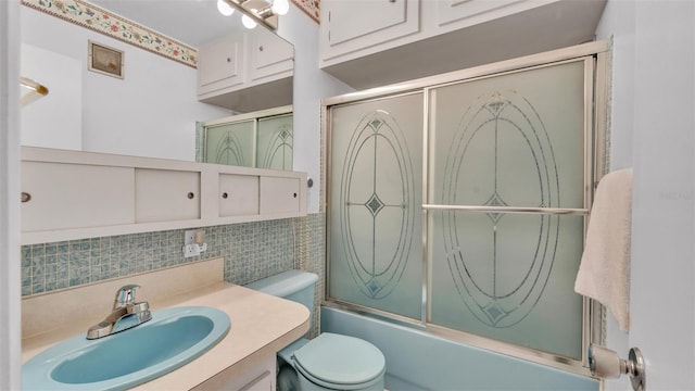 1600 W Lake Parker Dr Unit A2, Lakeland, FL 33805 - full bathroom with toilet, tile walls, vanity, backsplash, and enclosed tub / shower combo