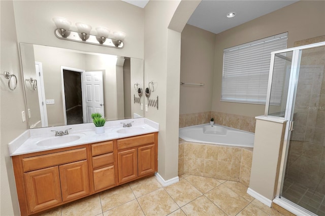 bathroom featuring tile patterned floors, shower with separate bathtub, and vanity